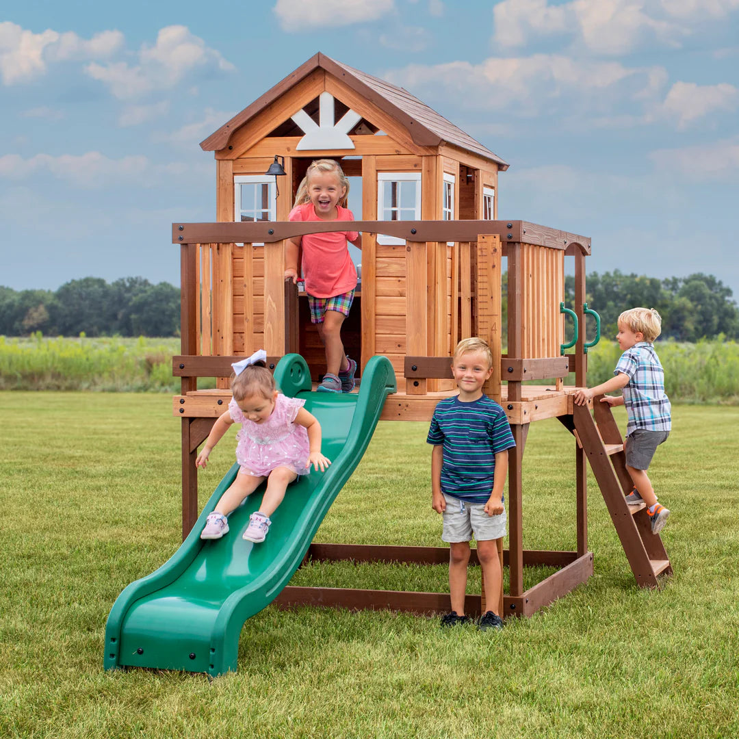 happy kids on playhouse and slide