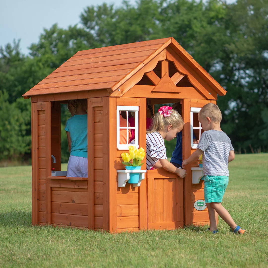 kids playing in pretend outdoor house